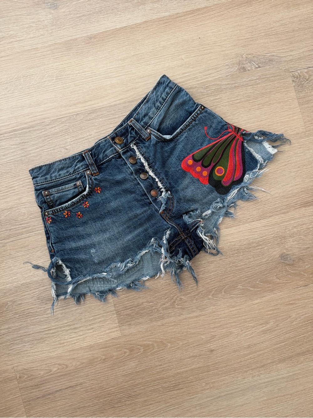 Free People Distressed Denim Shorts with Colorful Butterfly Wing